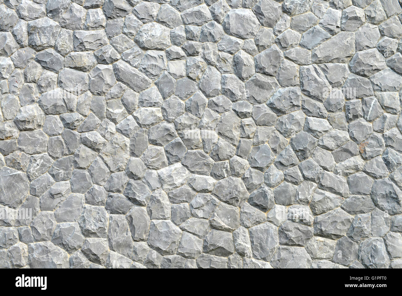 Graue Steinmauer Textur und Hintergrund Stockfoto