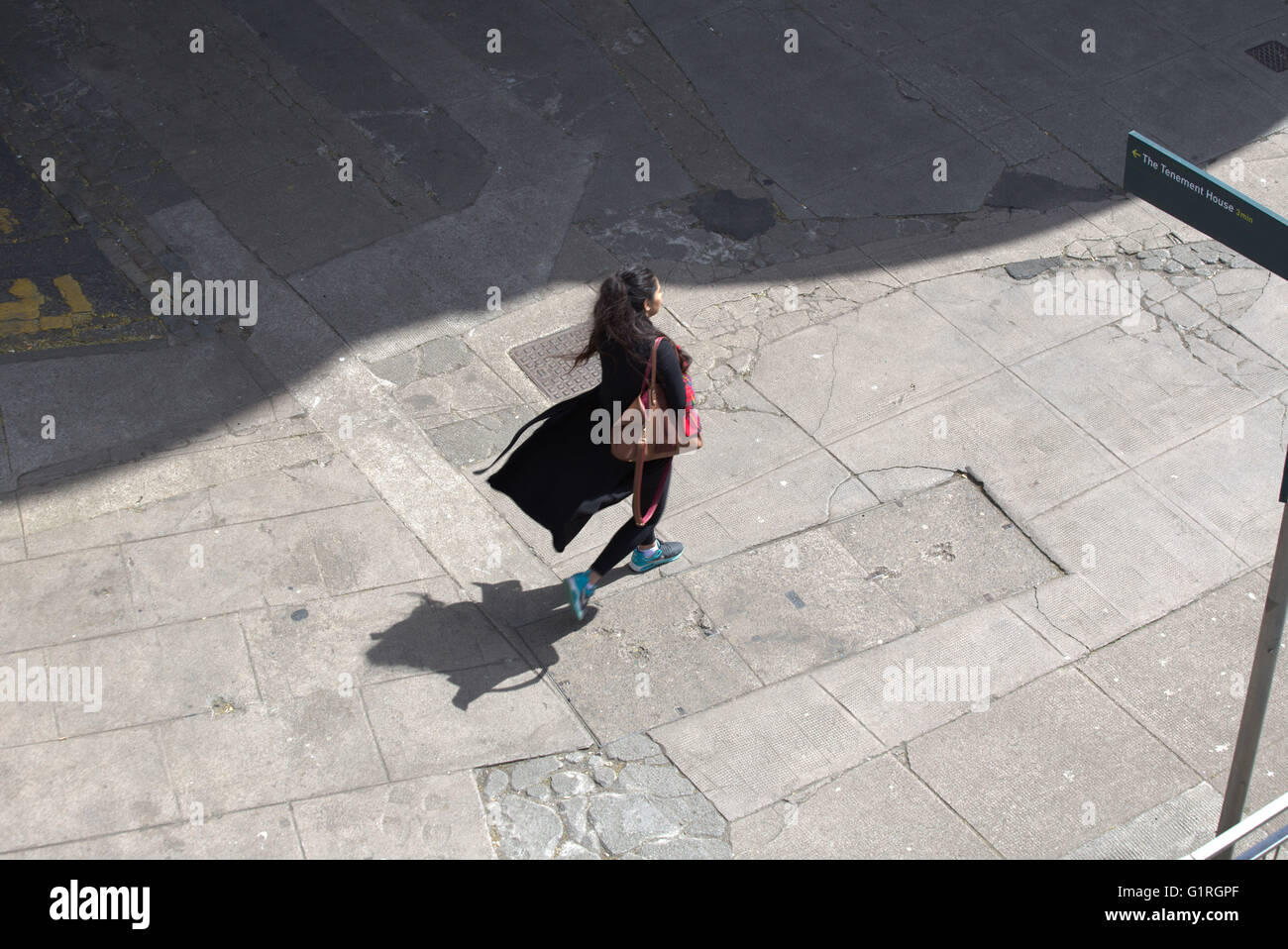 Junge trendiges Mädchen mit fließenden Kleid und Schatten gesehen von oben, Glasgow, Schottland, Großbritannien Stockfoto