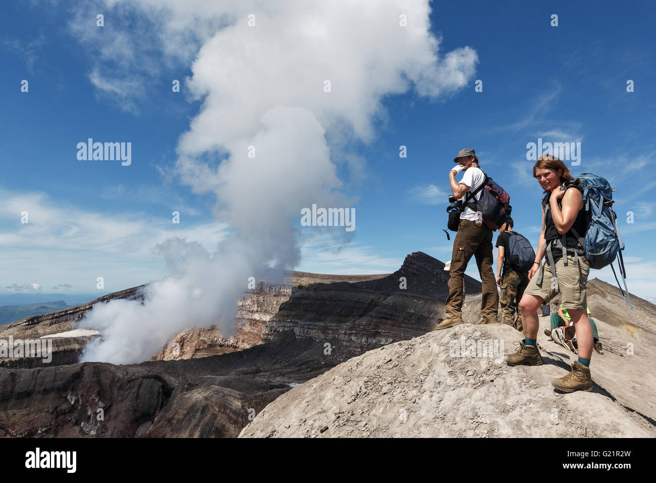 Touristen in den Krater des aktiven Gorely Vulkanbeobachtung auf die Arbeit des Vulkans Fumarolen. Russland, Fernost, Kamtschatka. Stockfoto