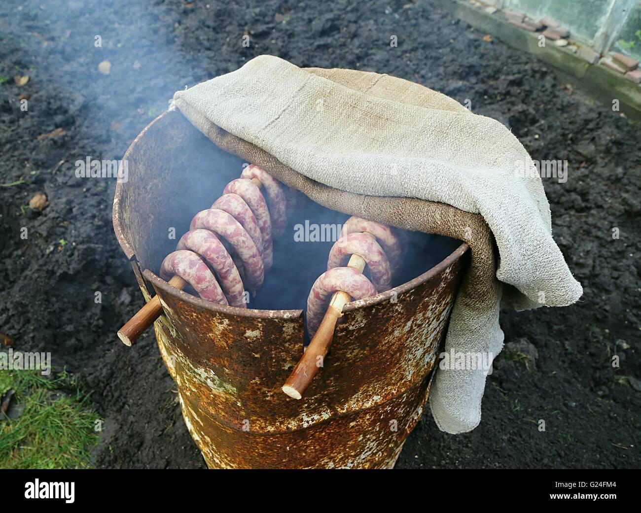 Geräucherte Würste in hausgemachten Räucherkammer im Garten. Stockfoto