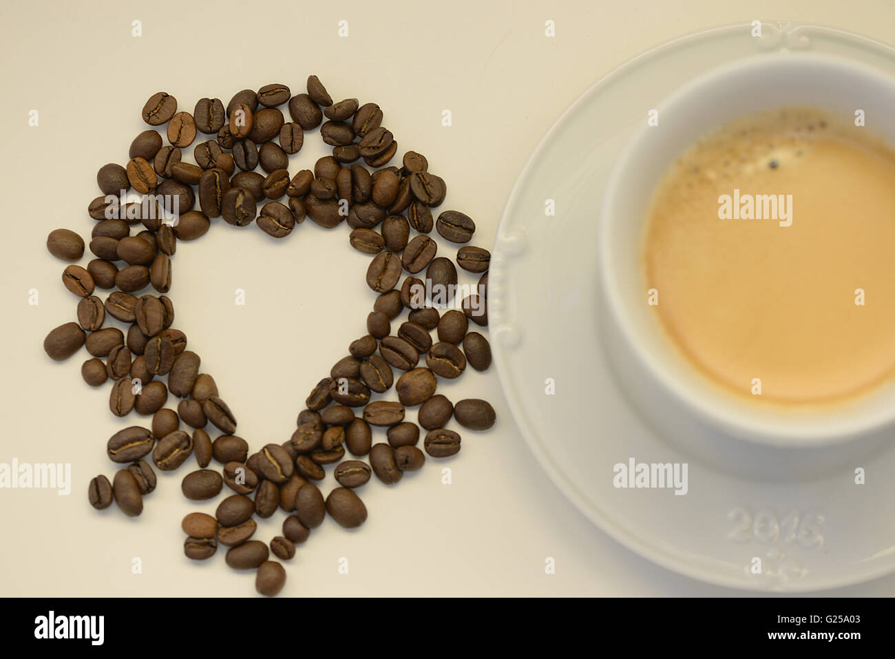 Tasse Kaffee und Kaffeebohnen in Form eines Herzens Stockfoto