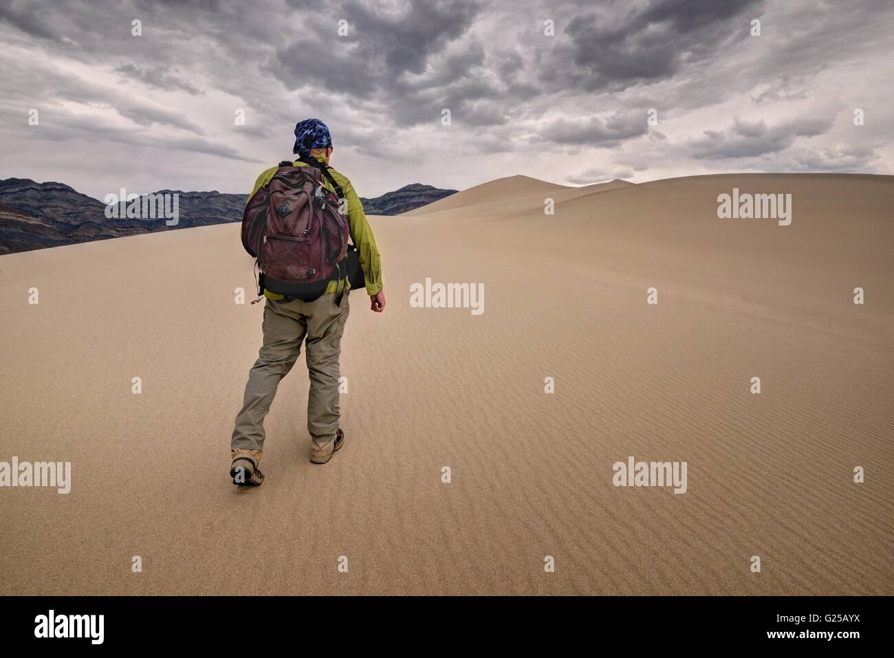 Mann, der durch Eureka Sand Dunes, Death Valley National Park, Kalifornien, USA läuft Stockfoto