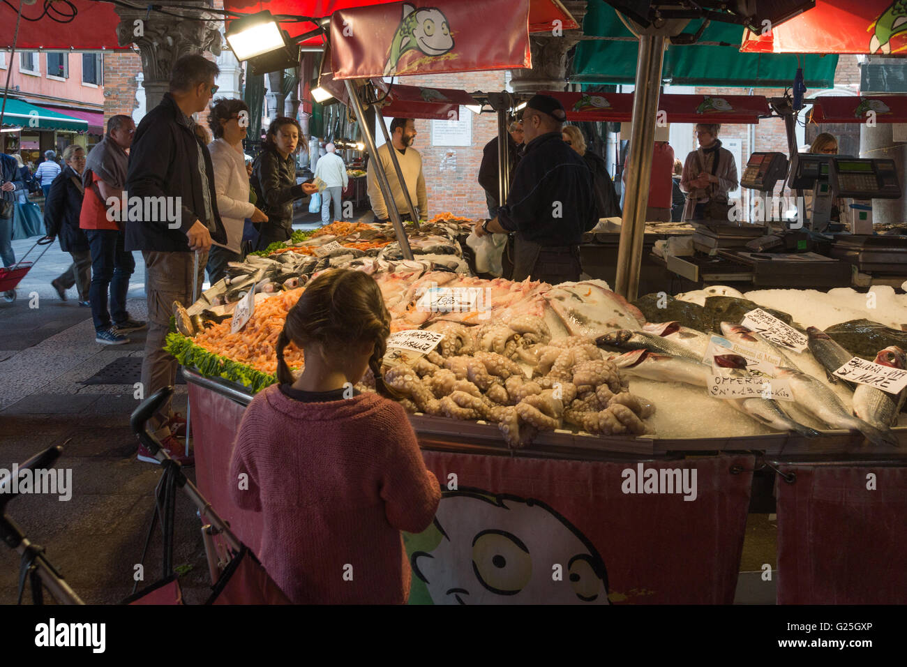 Ein kleines Mädchen, Blick auf die Fische zum Verkauf in Pescaria, Markt von Rialto, Venedig Stockfoto