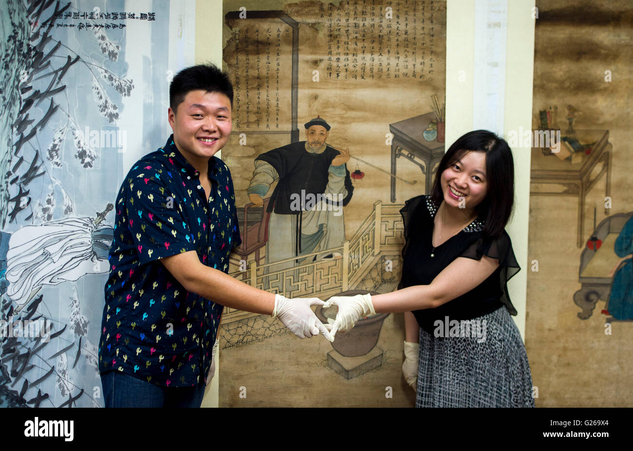 (160525)--WUHAN, 25. Mai 2016 (Xinhua)--Zhao Xiaolong (L) und seine Frau Zhang Xiaolong posieren für Fotos im Musée Hubei in Wuhan, der Hauptstadt der Provinz Zentral-China-Hubei, 16. Mai 2016. Zhang Xiaolong und Zhao Xiaolong, Ehepaar, das in den 1980er Jahren geboren sind beide arbeiten auf kulturelles Relikt Wiederherstellung der Hubei-Museum. Teilen gleichen Interesse für kulturelle Relikte im gleichen Alter, Zhao und Zhang, jedoch sind spezialisiert auf professionelle Facetten: Zhao widmet sich kulturelles Relikt Wiederherstellung und Zhang ist gut Materialerkennung. Sie bauen ihre Beziehungen durch Zusammenarbeit und tragen Stockfoto