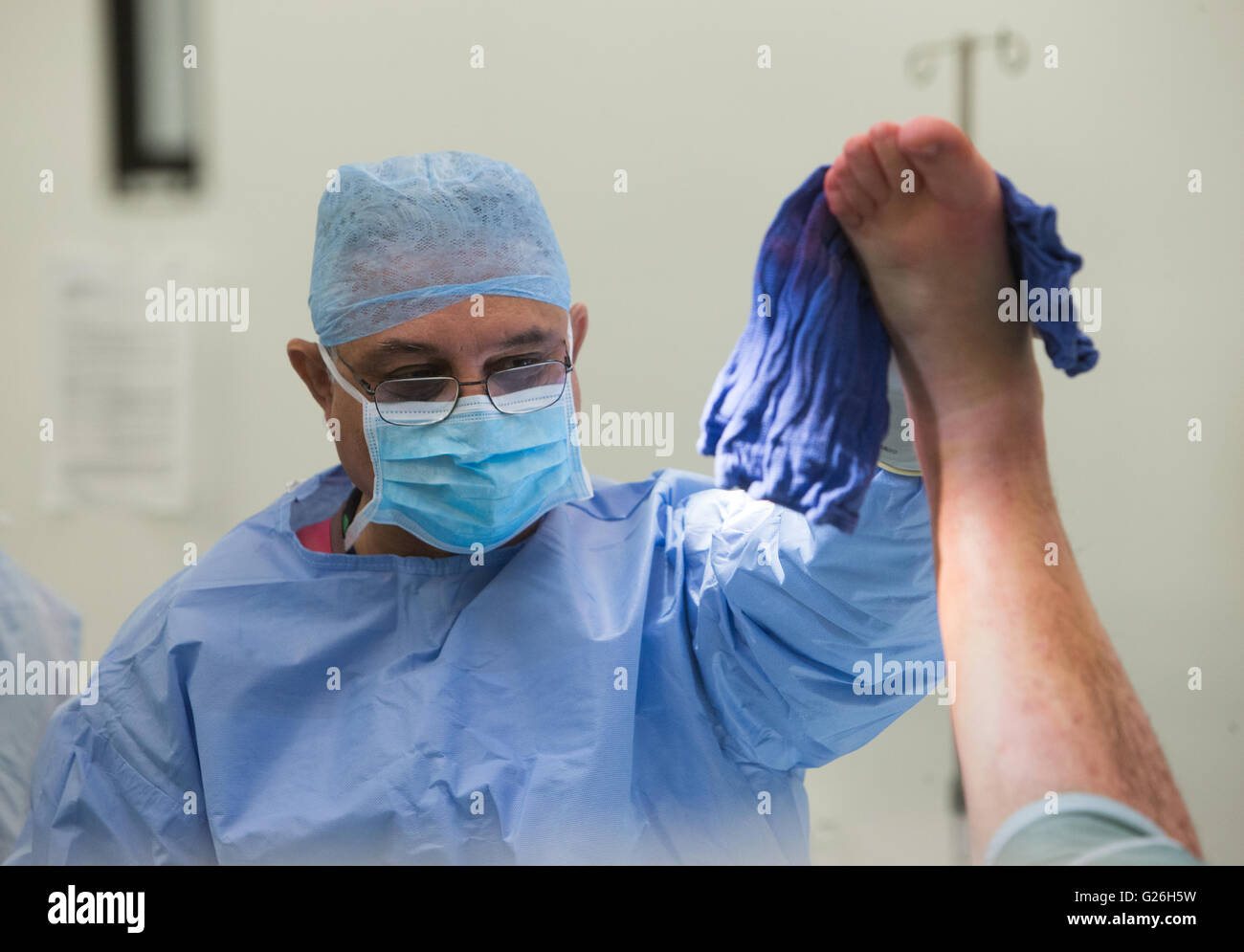 Ein Chirurg bereitet ein Patient für eine Operation vor der Durchführung einer offenen Reposition und Osteosynthese des linken Sprunggelenks Stockfoto