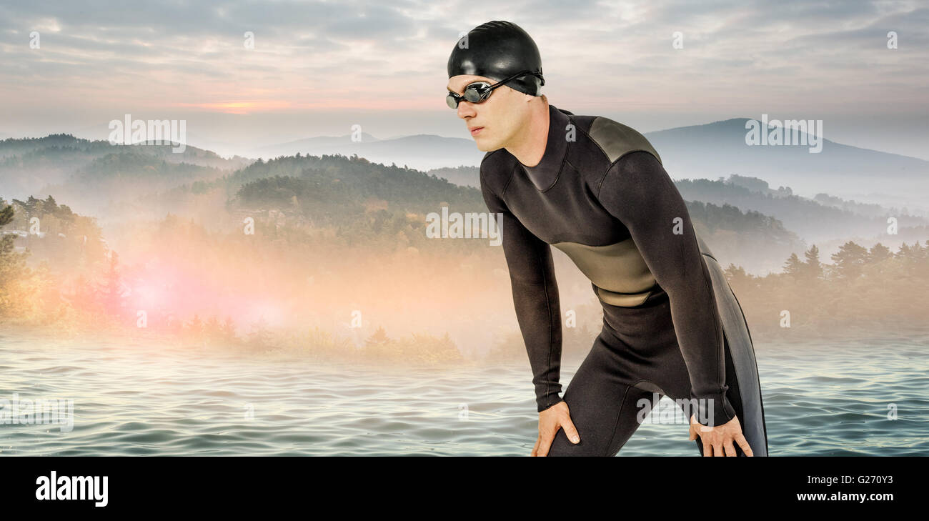 Zusammengesetztes Bild des Schwimmers in Neoprenanzug und Schwimmen Schutzbrille Stockfoto