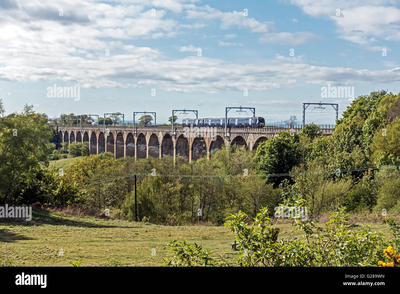 Ein Scotrail Class 170 geht in Linlithgow Viadukt nun voll ausgestattet mit Oberleitungen (Oberleitung) für elektrische Züge Stockfoto