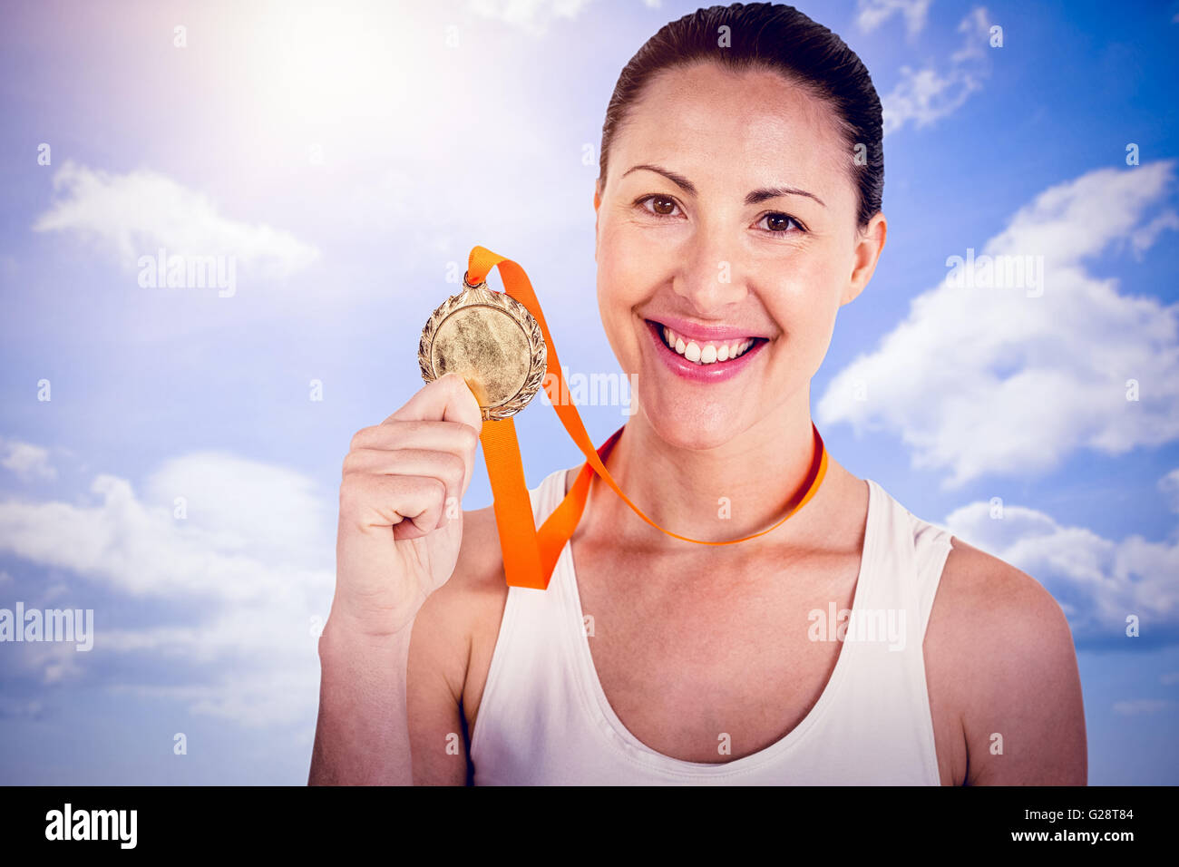 Zusammengesetztes Bild Sportlerin posiert mit Goldmedaillen nach Sieg Stockfoto