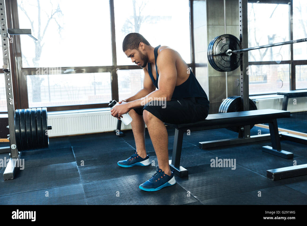 Afro american Fitness Mann ruht auf der Bank in der Turnhalle Stockfoto