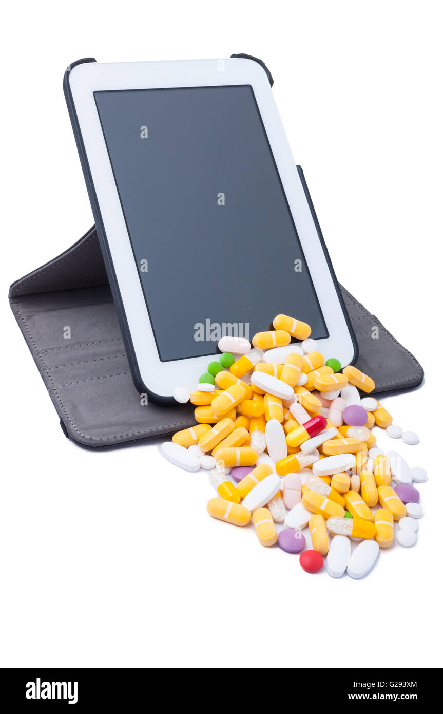 Farbigen Pillen aus drahtlosen Tablet isoliert auf weißem Hintergrund Stockfoto