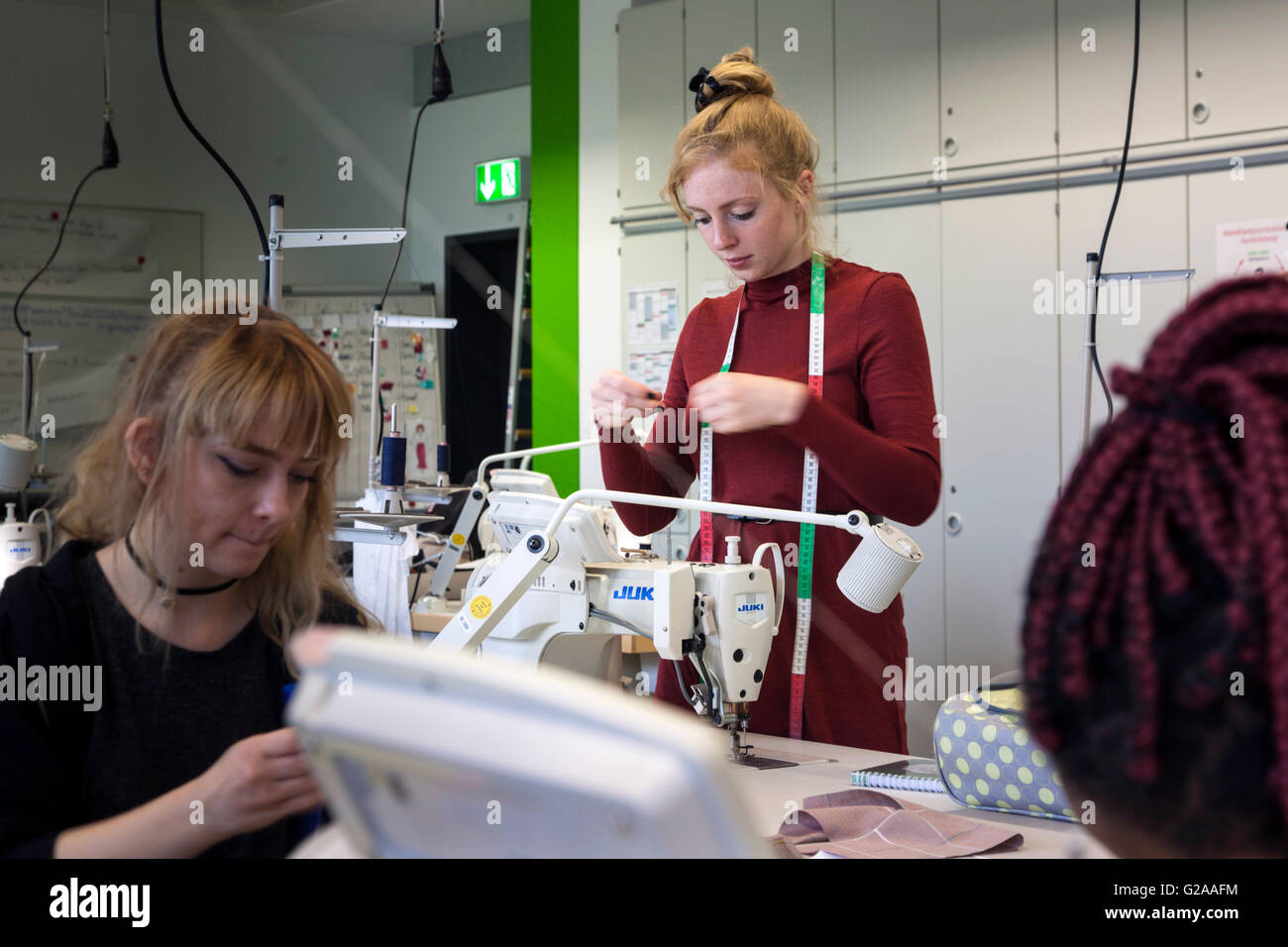 Praktischer Unterricht an der Nähmaschine für angehende Näherinnen Stockfoto