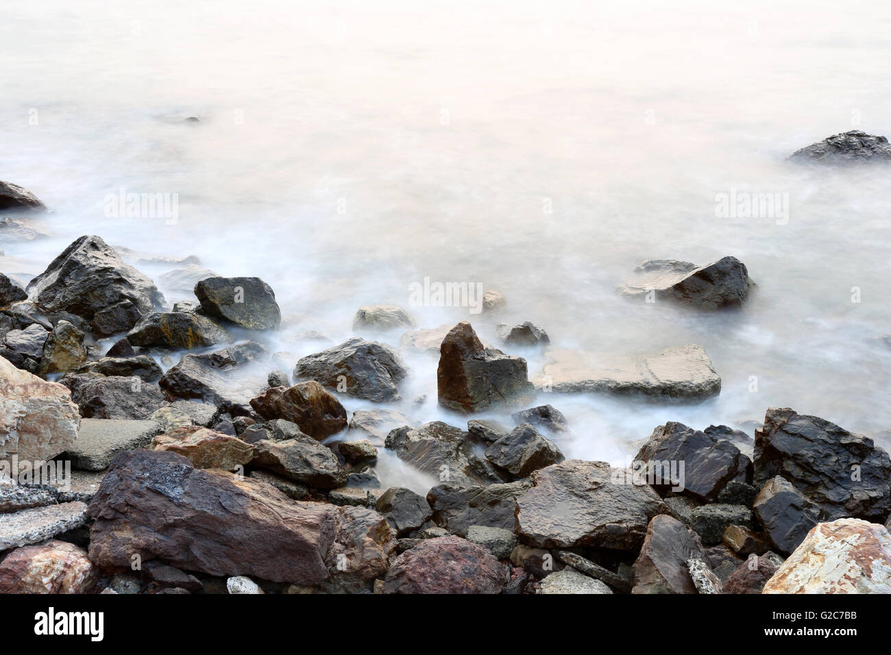 Meer Nebel Weichheit von den Gezeiten und den Sonnenuntergang am Abend mit Felsen im Vordergrund, Aussichtspunkt in Chanthaburi Thailand. Stockfoto