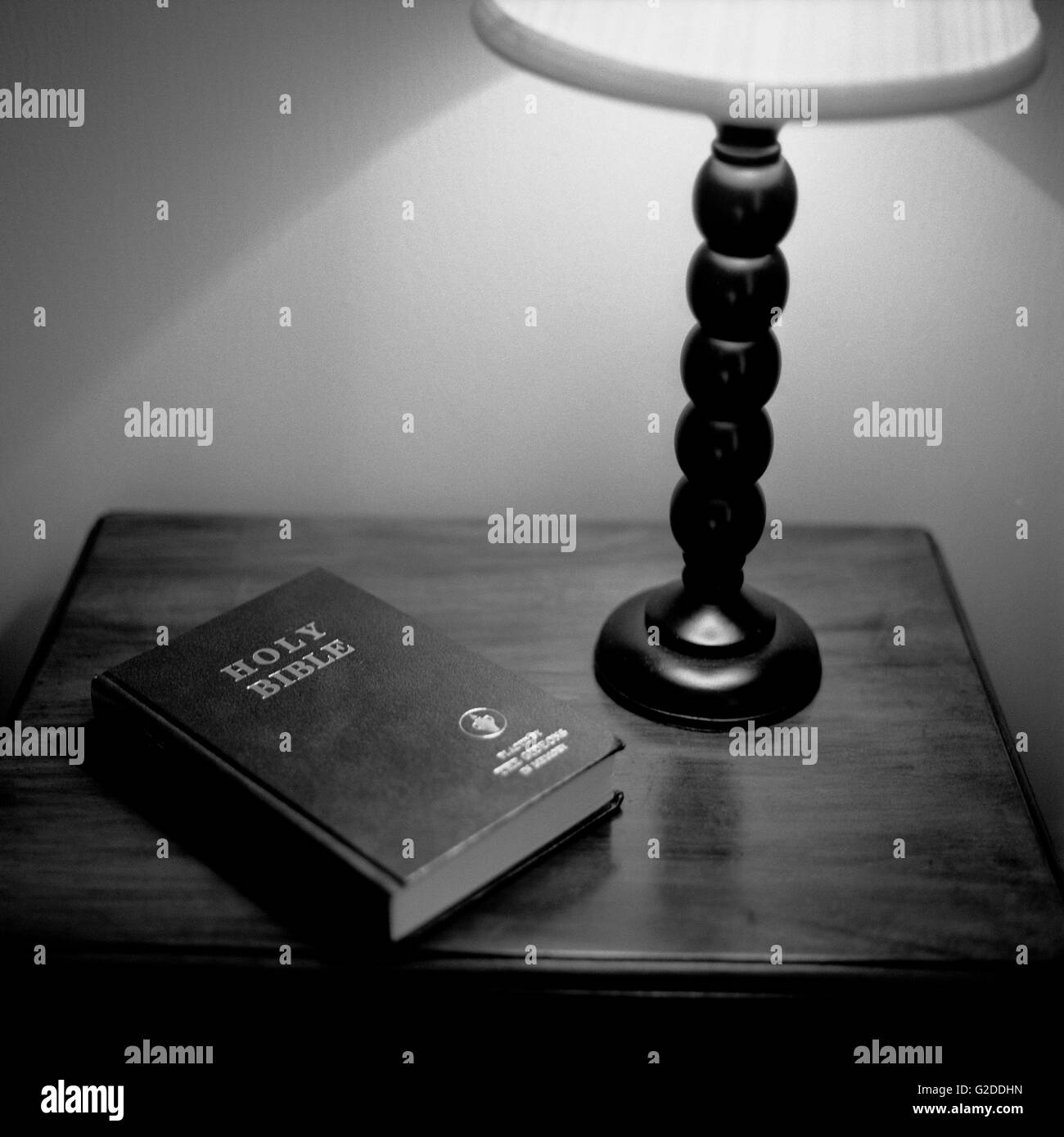 Bibel und Lampe auf dem Nachttisch Stockfoto