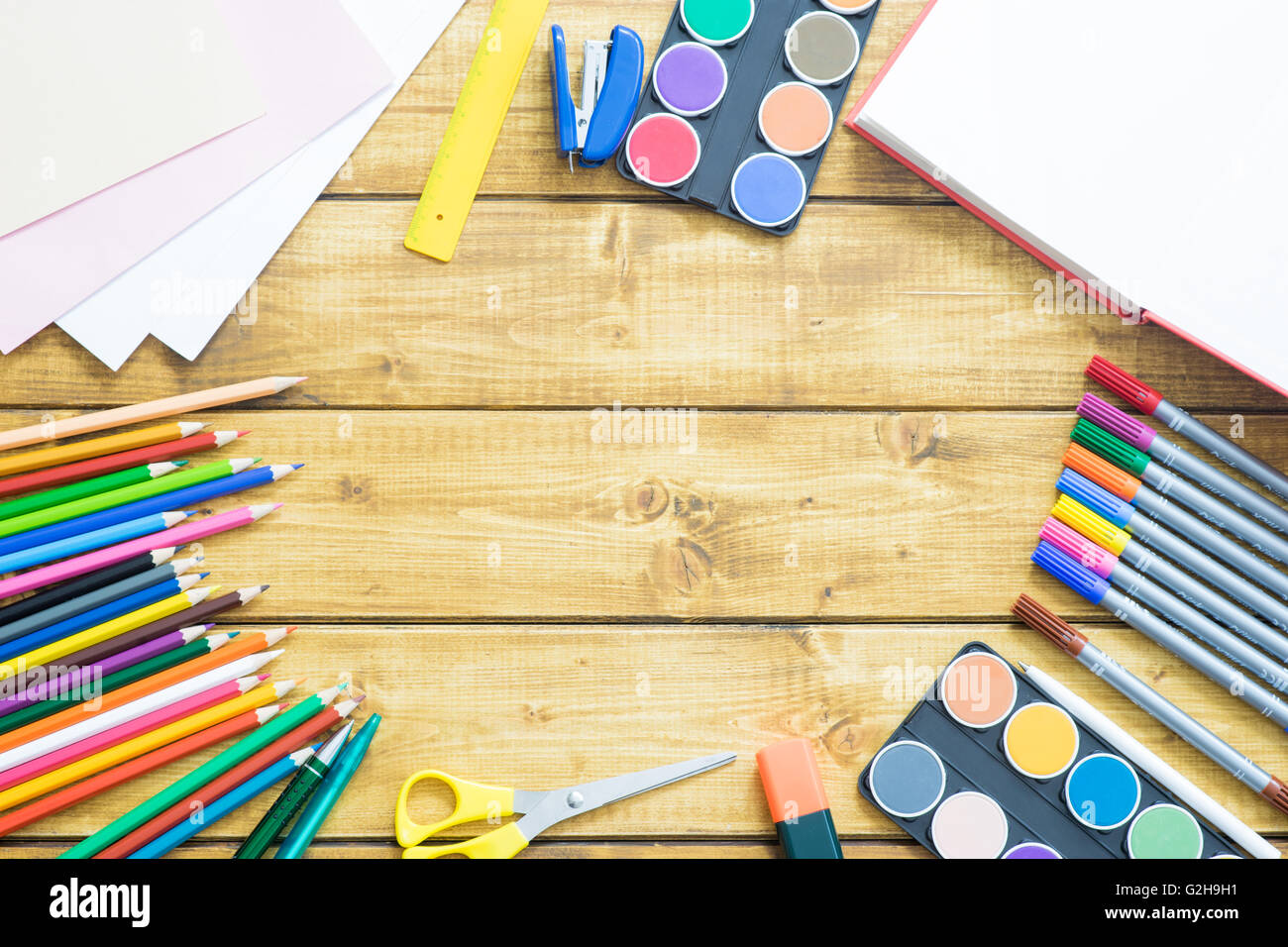 Schule-Elemente machen einen Frame auf hölzernen Hintergrund Stockfoto