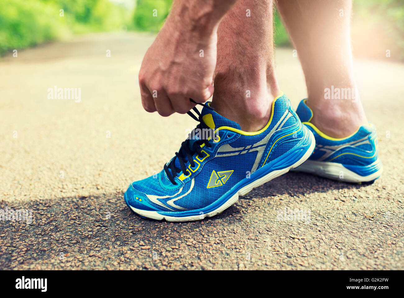 Läufer seine Laufschuhe binden. Straße Wald Mann Schnürsenkel Turnschuhe Stockfoto