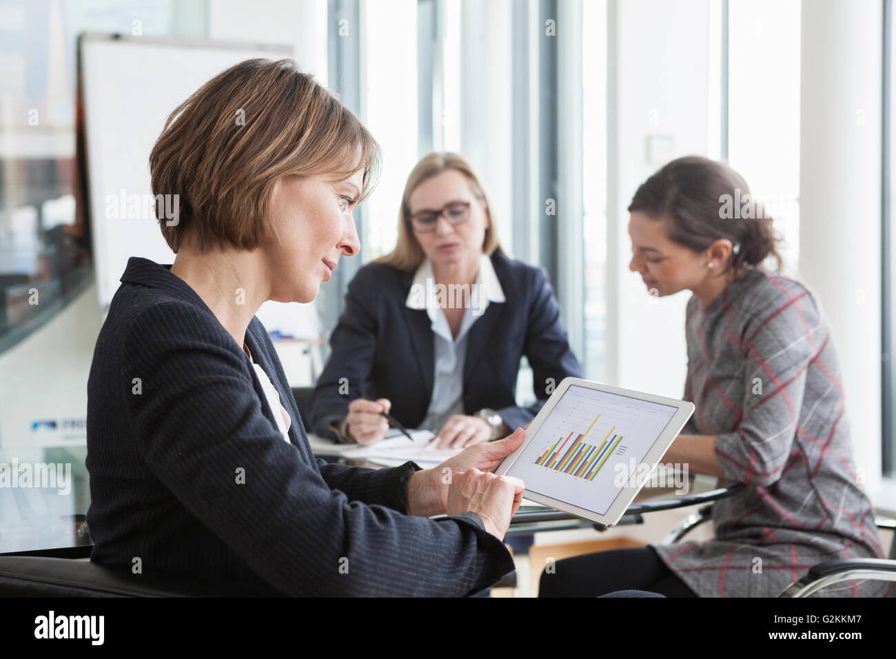 Geschäftsfrau mit digital-Tablette in einer Besprechung Stockfoto