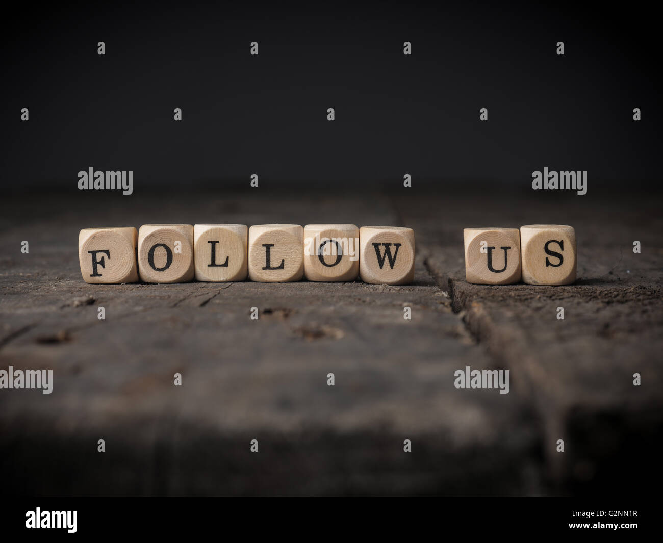 Kleine hölzerne Würfel mit den Worten folgen Sie uns Stockfoto