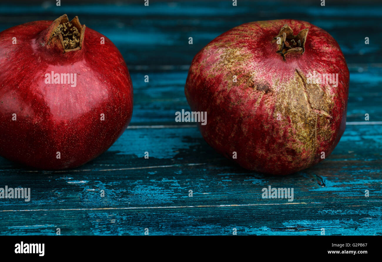 Frische helle rote Granatapfel auf blauem Hintergrund aus Holz Stockfoto