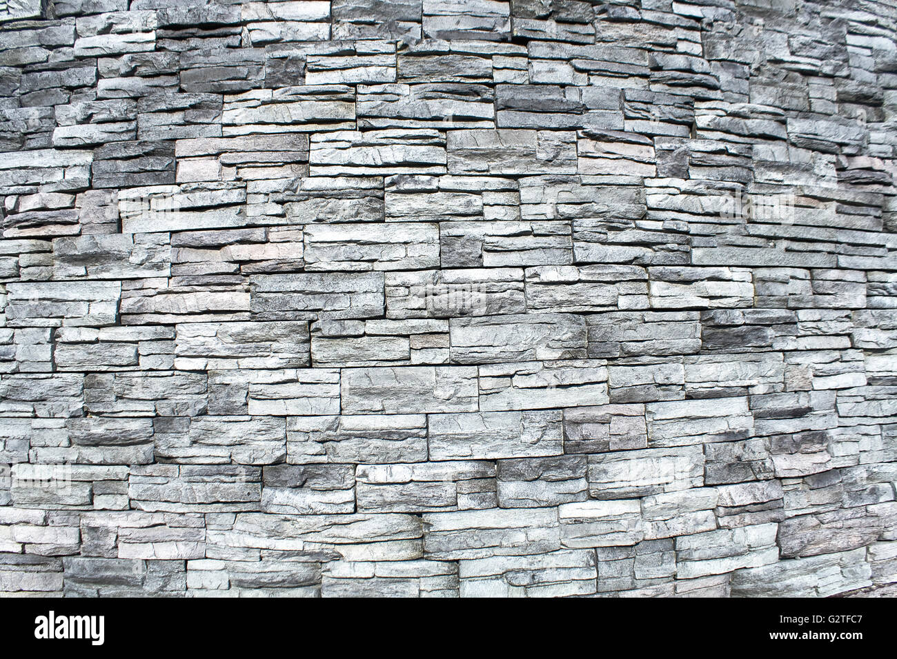 Ovale Stein Wand Textur als Hintergrund Stockfoto