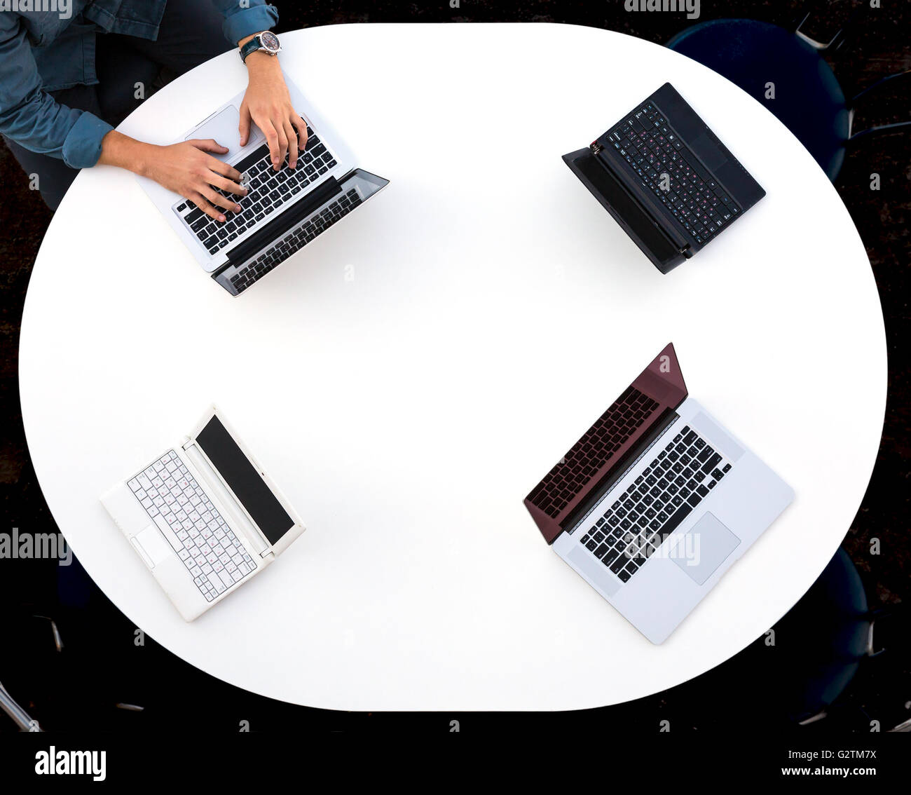 Draufsicht der abgerundete Schreibtisch mit vier Laptops Stockfoto