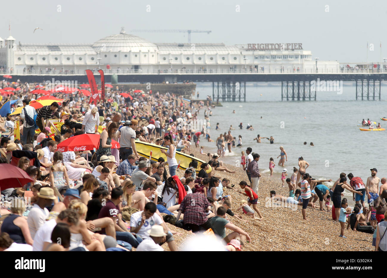 Sonnenanbeter am Strand in Brighton, Sussex, als Temperaturen sollen in der Mitte der zwanziger Jahre nach einer Woche von Wolken und kühle Temperaturen im Süden und Osten des Landes erreichen. Stockfoto