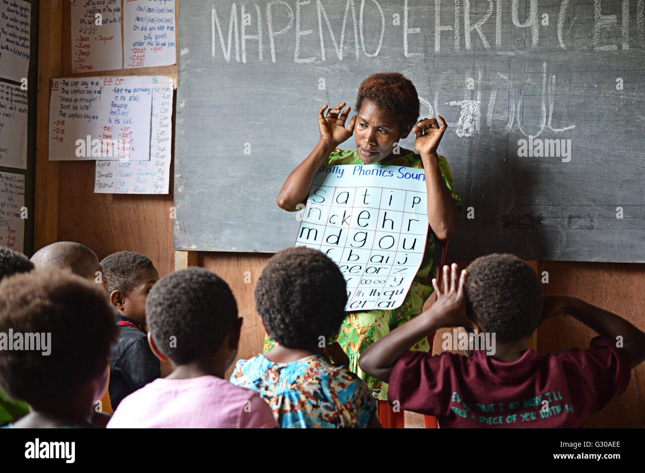 Frühen Kindheit Lehrer Unterricht eine ganze Klasse Phonics Sitzung am Mapemo früh Lernzentrum in Goroka, Papua-Neu-Guinea Stockfoto