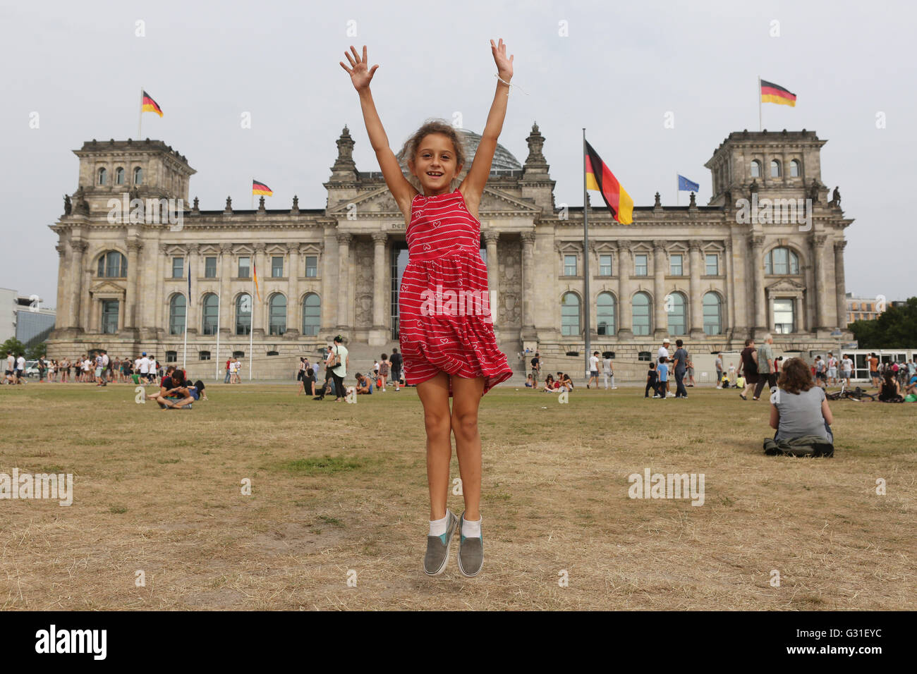 Berlin, Deutschland, springt kleines Mädchen vor dem Reichstagsgebäude fröhlich in der Luft Stockfoto