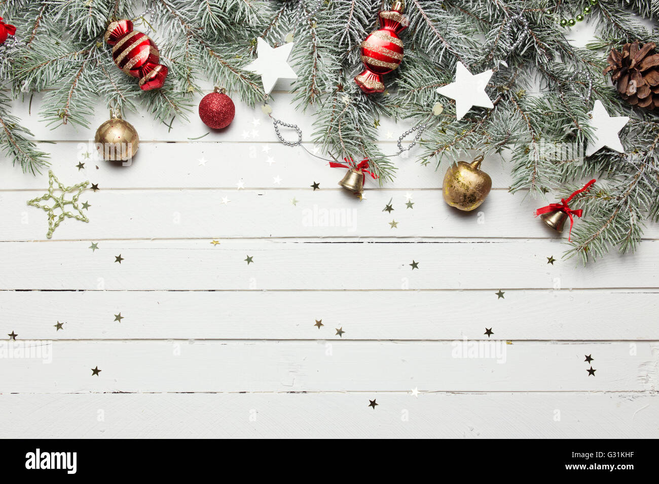 Weihnachten oder Silvester-Dekoration-Hintergrund: Tanne Äste, bunte Glaskugeln und glitzernden Sternen auf weißem Holz Hintergrund, Ansicht von oben kopieren Raum Stockfoto