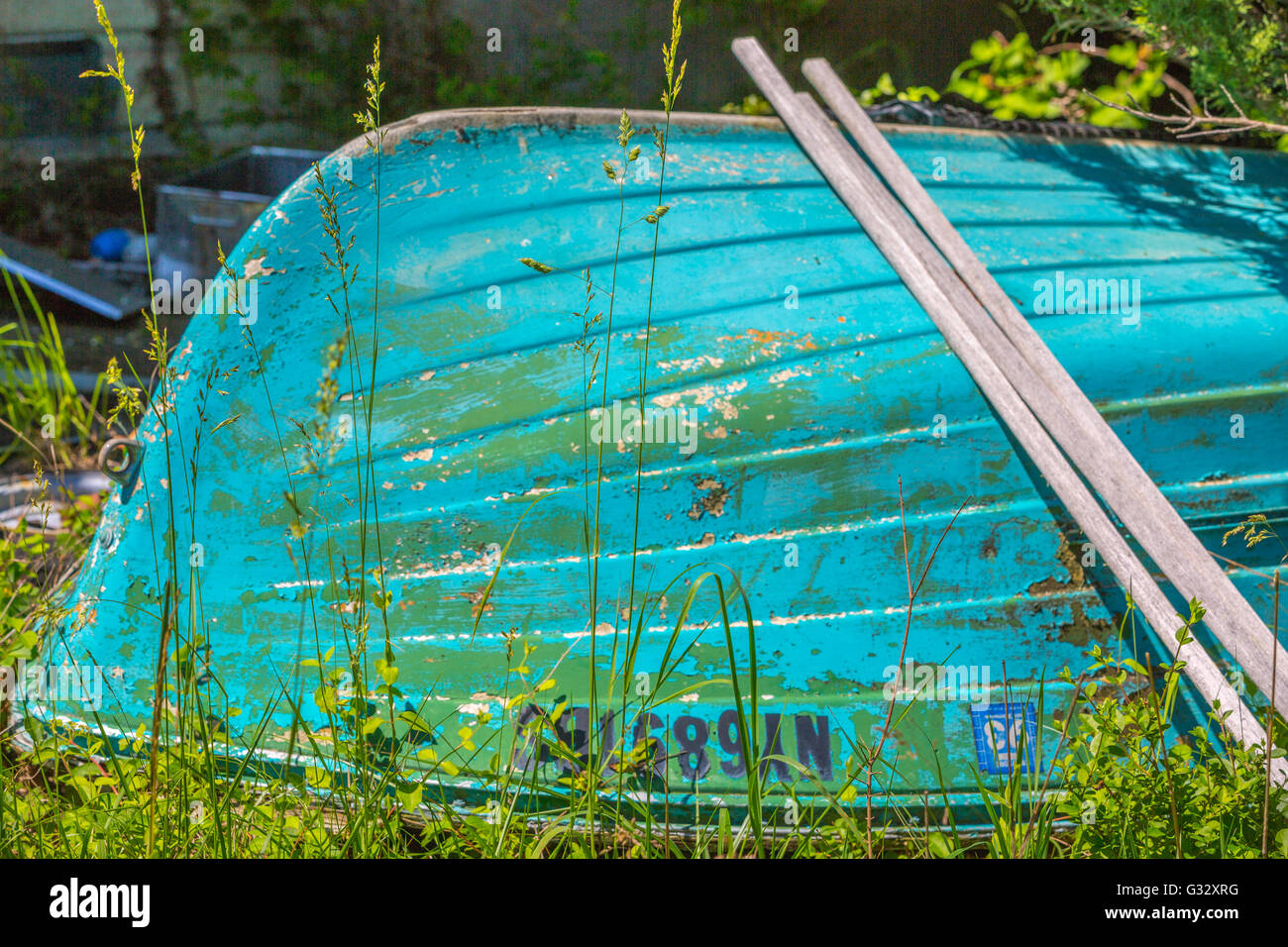 Detail-Bild von einer alten Fiberglasboot Verlegung in einem verwilderten Garten Stockfoto
