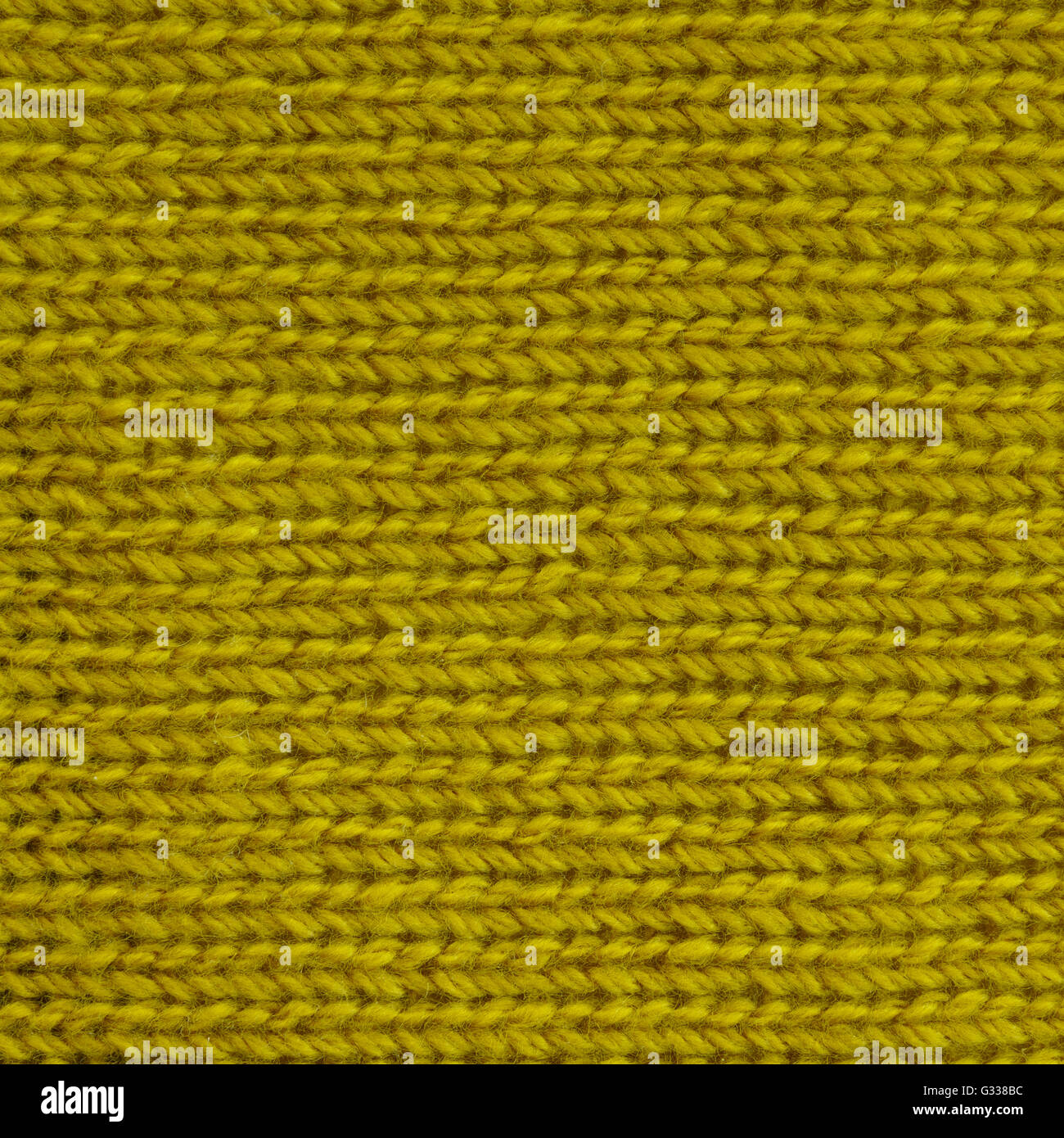Gelbes Curry Wolle gestrickte Gewebe. Fragment der Draufsicht hautnah. Stockfoto