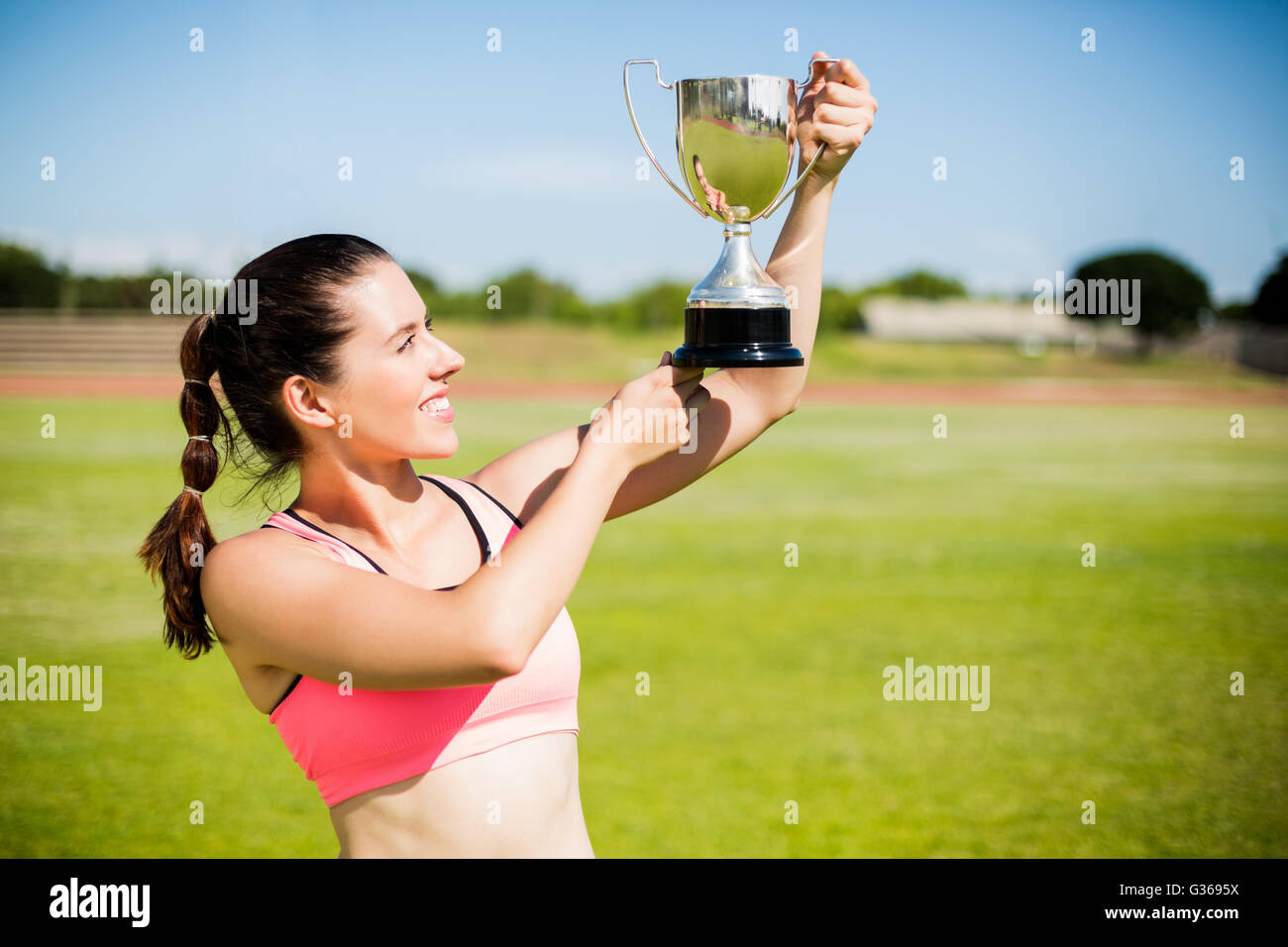 Glücklich Sportlerin zeigt ihre Trophäe Stockfoto