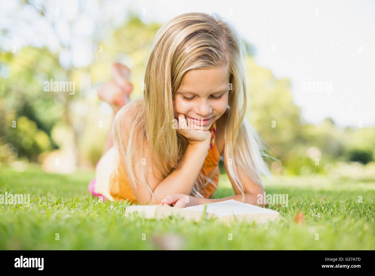 Junges Mädchen Lesebuch im park Stockfoto