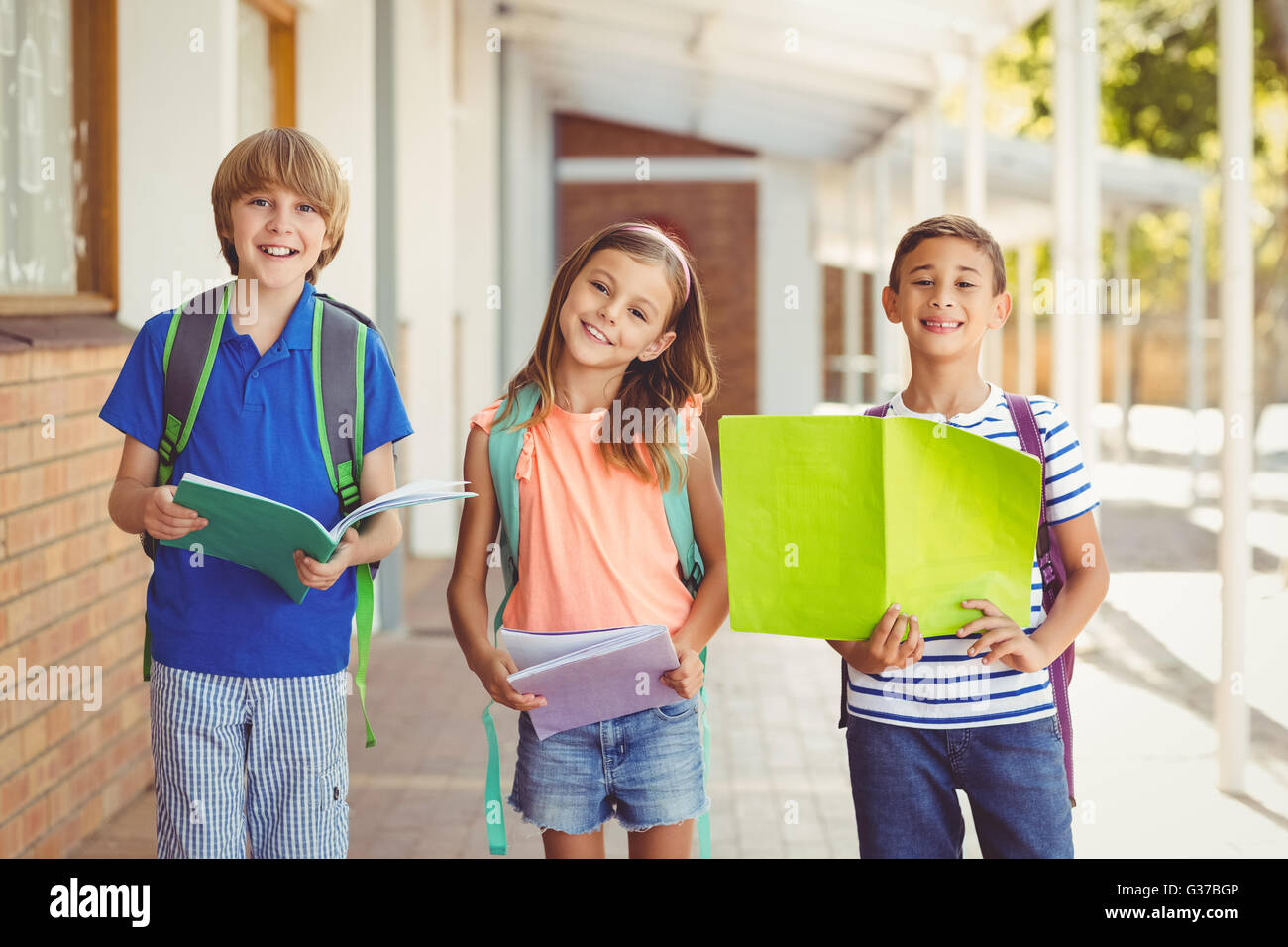 Porträt des Lächelns Schulkinder stehend im Flur der Schule Stockfoto