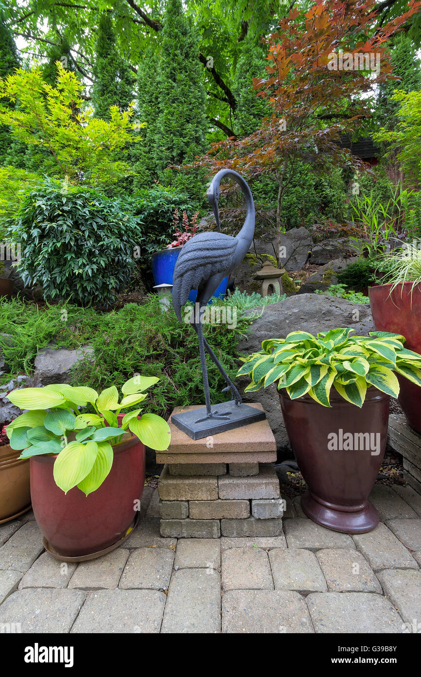 Garten Garten japanische asiatisches Thema Design Landschaftsgestaltung mit Pflanzen Kran Skulptur und Steinlaterne Stockfoto