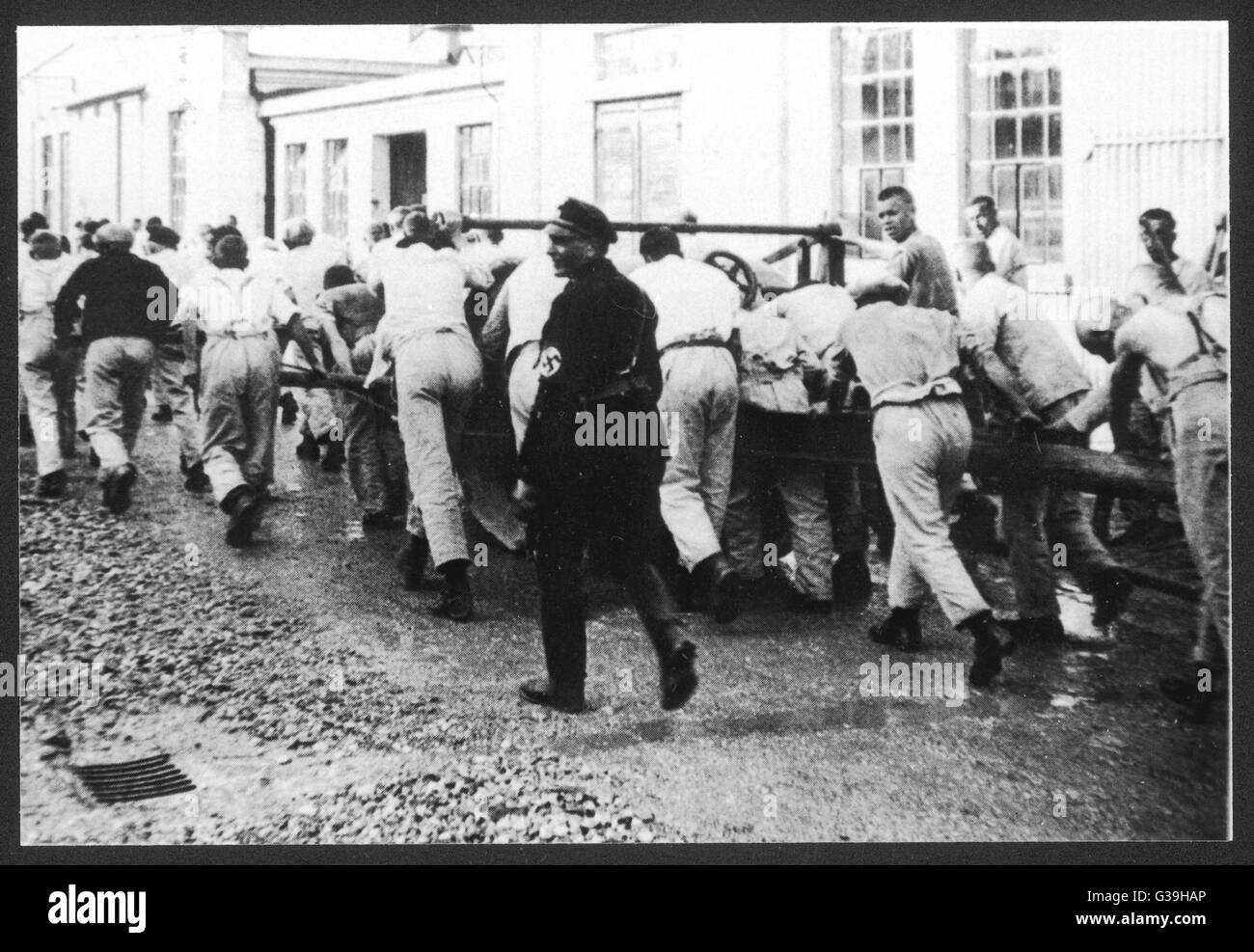 Zwingt die Häftlinge im KZ Dachau zu arbeiten.        Datum: 1933 Stockfoto