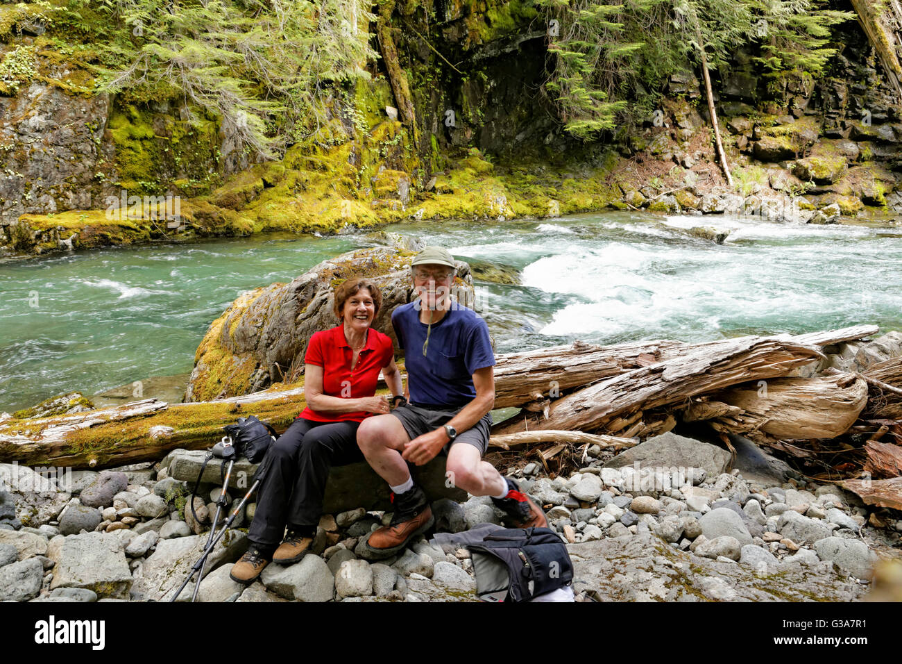 41,795.08221 Mann und Frau sitzen auf einem Felsen in einer Schlucht neben den schnell fließenden Fluss der Chinook Stockfoto