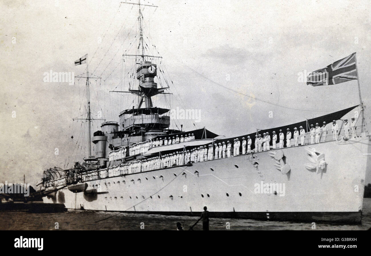 HMS Hawkins (D86), britischer schwerer Kreuzer.  Sehen hier in Saigon Dockside mit der Crew an Deck aufgereiht.      Datum: ca. 1920 Stockfoto