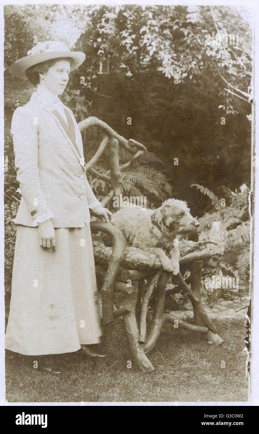 Eine Frau mit einem Hund im Garten Stockfoto