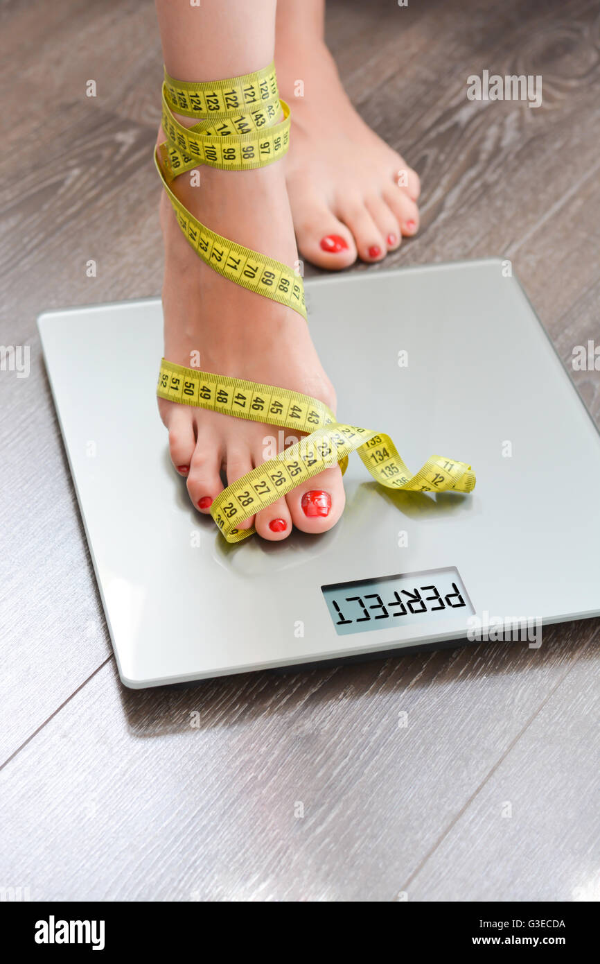 Gewichtskonzept mit Person auf einer Skala messen Kilogramm zu verlieren Stockfoto