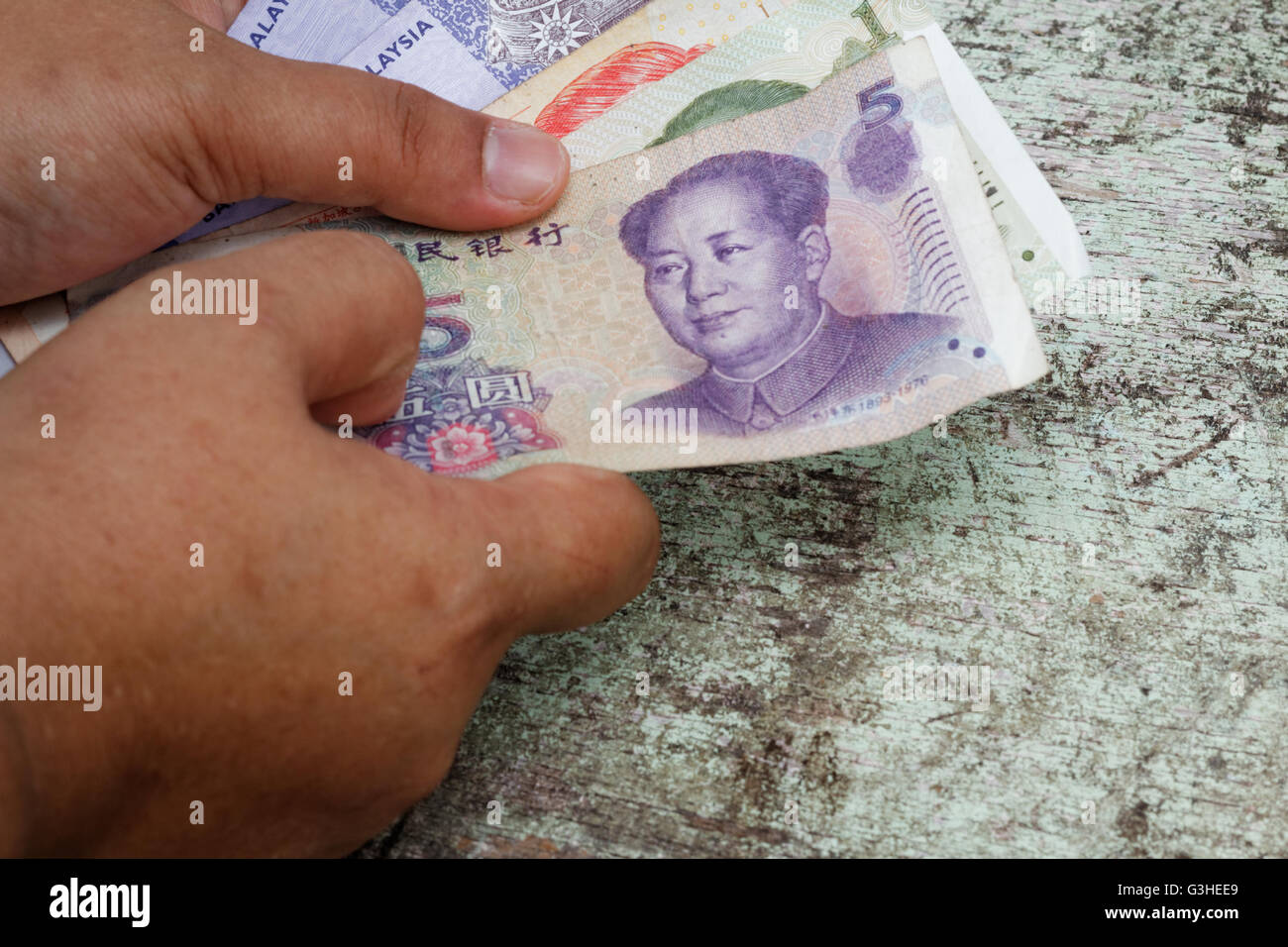 Hand halten Geld in anderen Währung - malaysische Ringgit, Singapur-Dollar und China Renminbi. Konzept der Arbeit verschiedenen Stockfoto