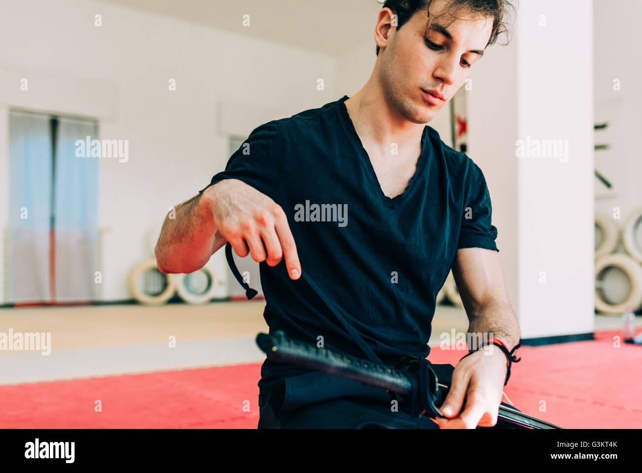 Kampfkünstler in Turnhalle Vorbereitung Schwert Stockfoto