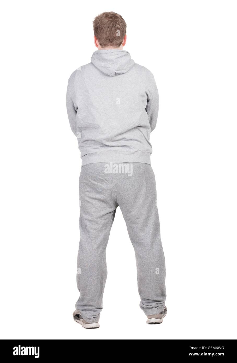Rückansicht der jungen Sportler Guy im Trainingsanzug schaut Weg. Sicht nach hinten. Isoliert auf weißem Hintergrund. Stockfoto