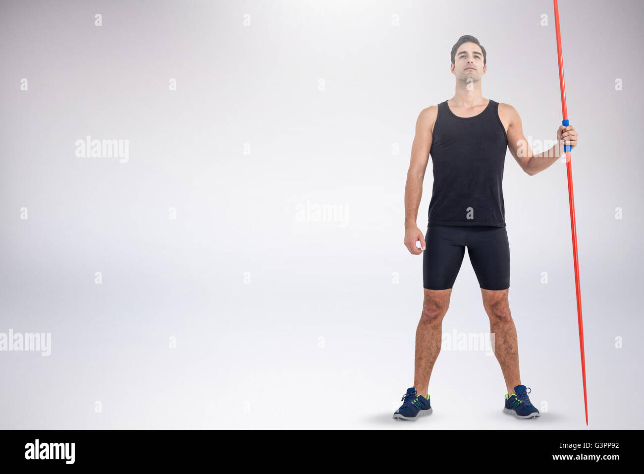 Zusammengesetztes Bild zuversichtlich männlicher Athlet hält Speer Stockfoto