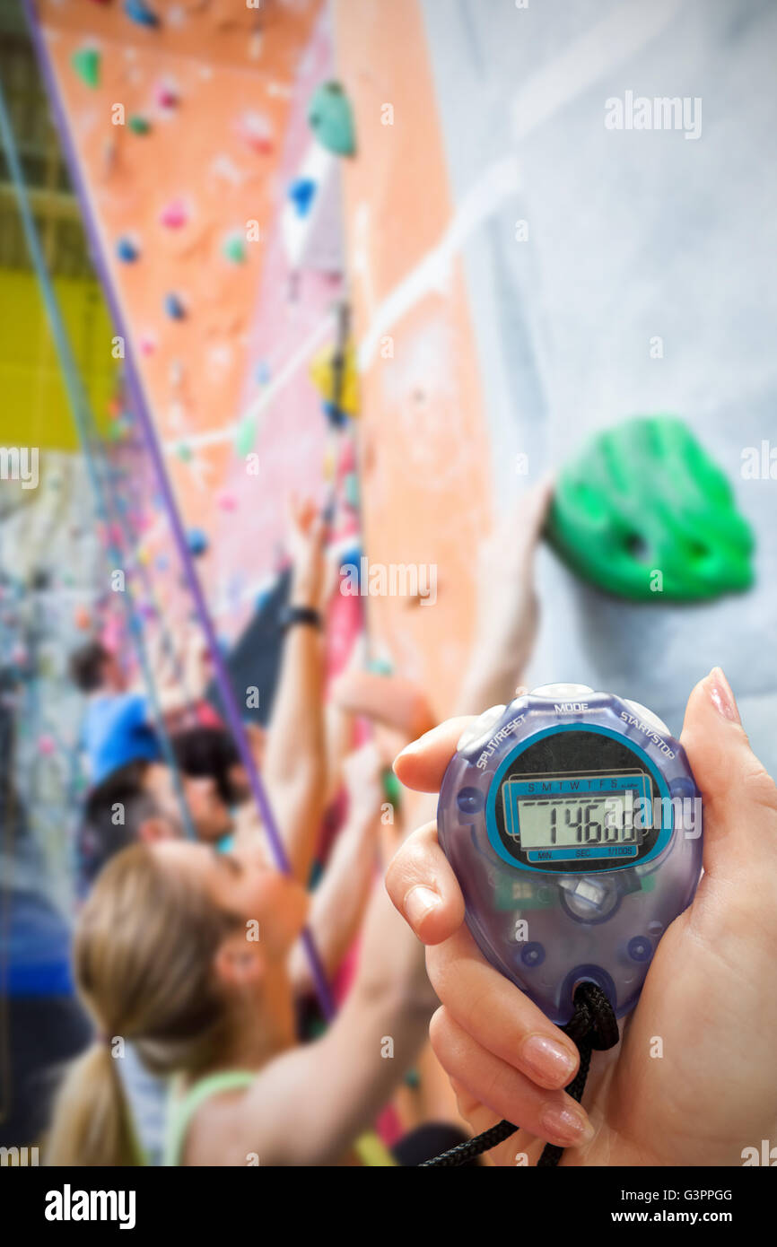 Zusammengesetztes Bild von Close Up von einer Hand hält einen Timer auf weißem Hintergrund Stockfoto