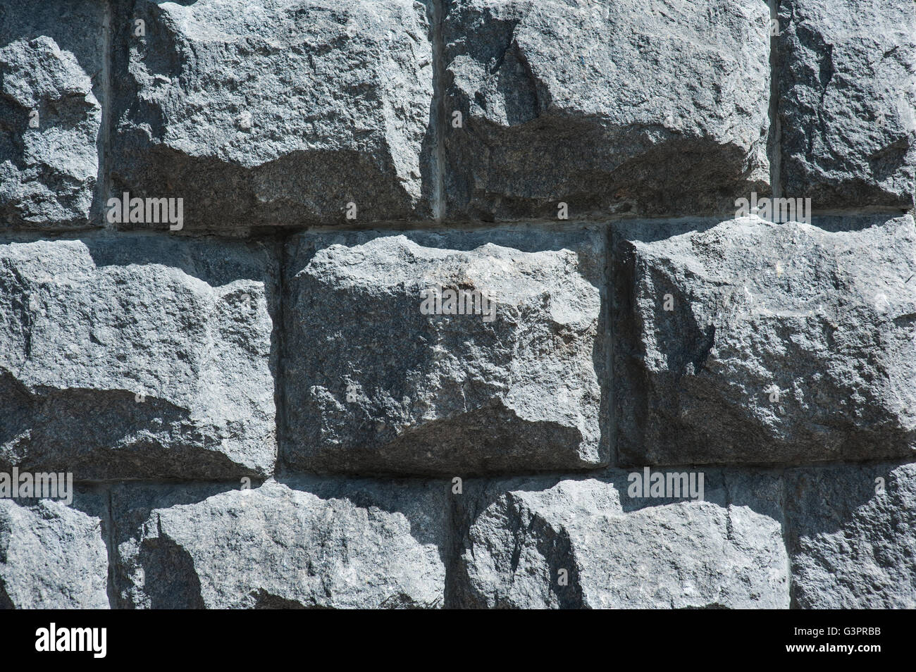 alte Mauer aus großen schwarzen verschiedenen Steinen Oberfläche Hintergrund Stockfoto