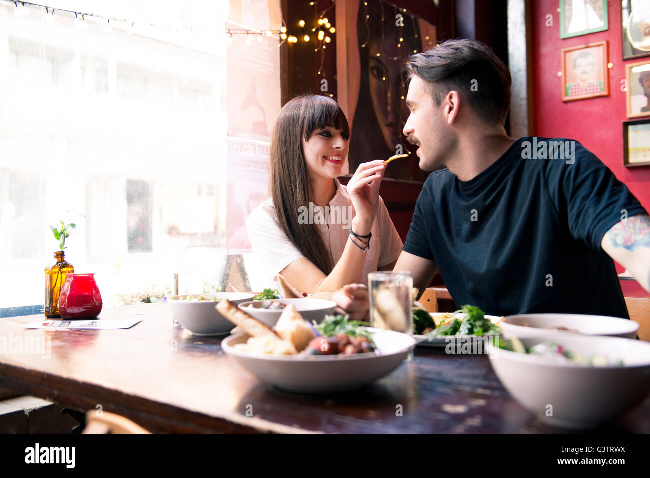 Ein junges Paar genießen Sie eine Mahlzeit zusammen in einem Coffee Shop in Manchester. Stockfoto
