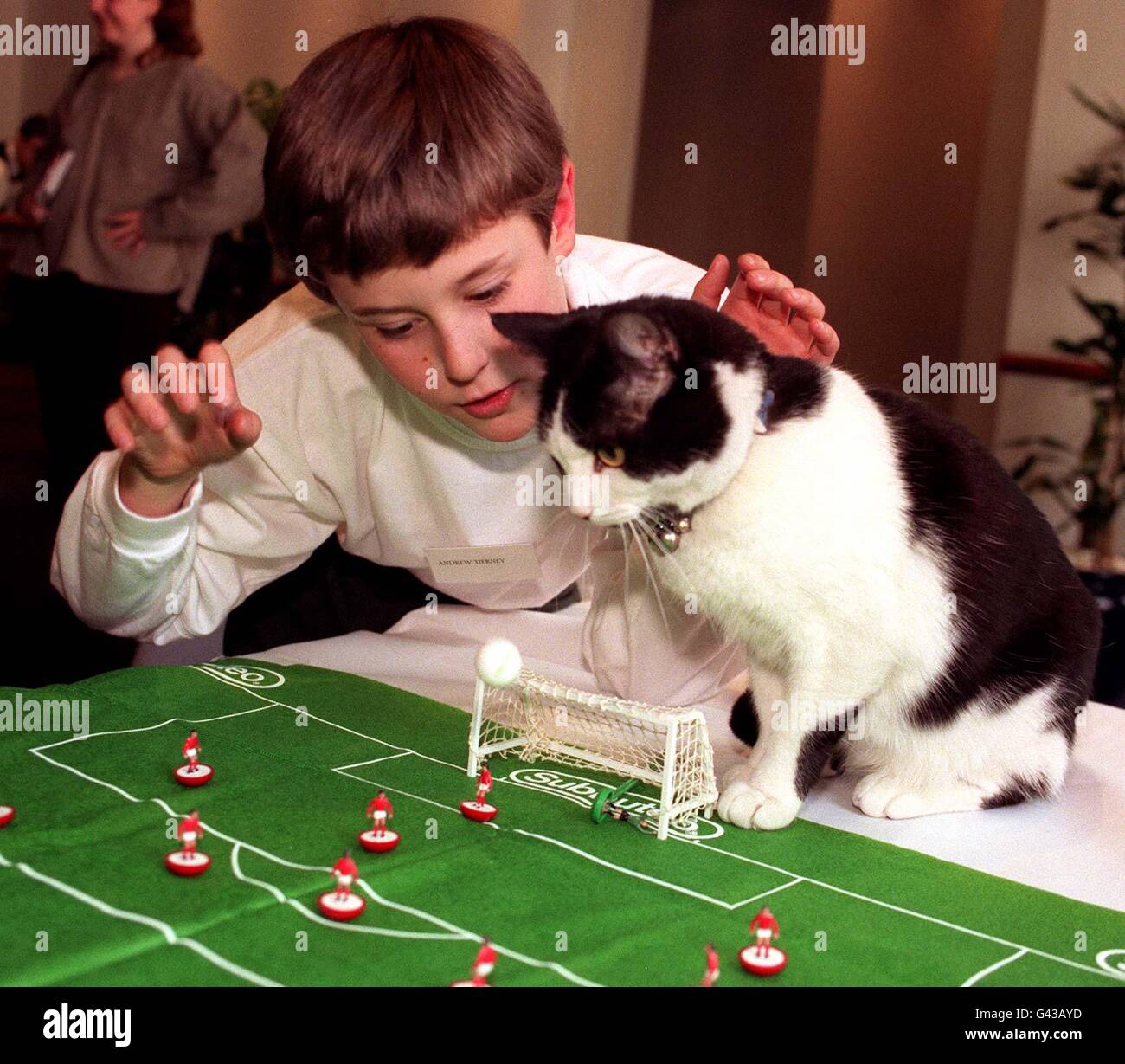 Jimmy, der Kater, ein begeisterter Subbuteo-Spieler, mit seinem Besitzer, dem 10-jährigen Andrew Tierney aus Cowling, North Yorkshire, heute Nachmittag (Mittwoch) in London, nachdem er zur Katze des Jahres ernannt wurde. Die vierjährige schwarz-weiße Katze wurde gerettet, nachdem er auf ein Lagerfeuer geworfen wurde und ist nun ein begeisterter Fußballfan geworden. Stockfoto