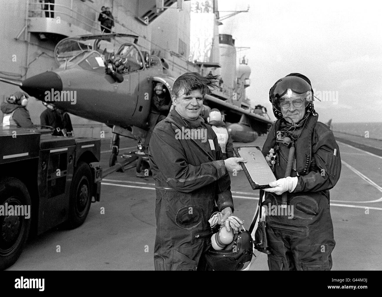 Bibliotheks-Filer Nr. 226501-1, datiert 8.2.88, des ehemaligen Testpiloten Bill Bedford (rechts), der als erster einen Prototyp eines Harrier-Sprungjets auf einem Flugzeugträger landet und eine Gedenktafel an Captain Mike Harris übergibt, Dann kommandierender Offizier der HMS Ark Royal, am 25. Jahrestag der Veranstaltung. Herr Bedford ist gestorben, wie heute (Montag) bekannt gegeben wurde. PA. SIEHE PA GESCHICHTE TOD BEDFORD. **nur in Schwarzweiß verfügbar** Stockfoto