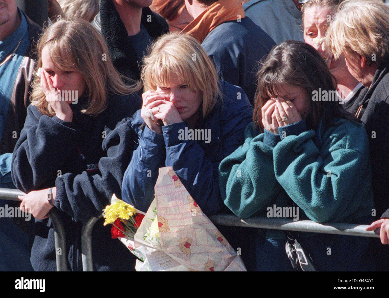 Drei junge Frauen weinen während der Trauerzug von Diana, Prinzessin von Wales, in London 06 September.PENNY/AFP POOL Stockfoto