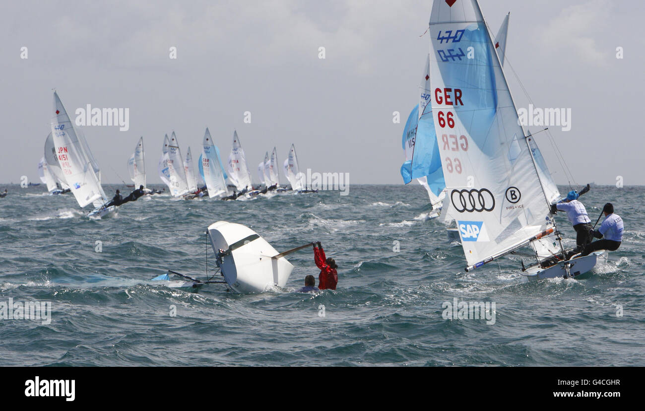 Anna Burnett und Flora Stewart versuchen während des zweiten Tages der Skandia Sail for Gold Regatta in Dorset, ihr kengelauftes Beiboot in der 470-Klasse der Frauen zu rekuppeln. Stockfoto